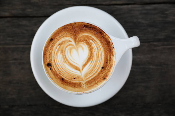 istock Cappuccino coffee cup on wood background 981753428