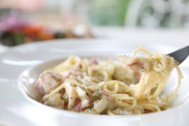 istock Spaghetti carbonara white sauce with bacon and cheese 981753454