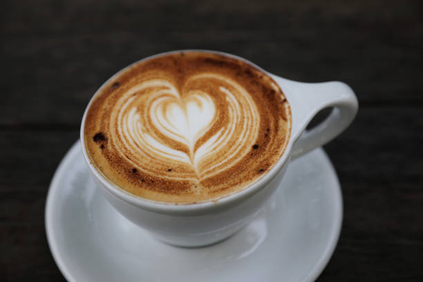 istock Cappuccino coffee cup on wood background 981753474