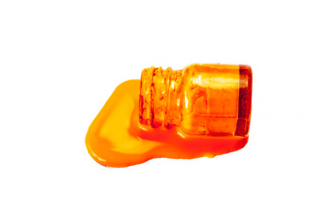 istock Orange poster color dropping or fallen on a white surface. 981753764