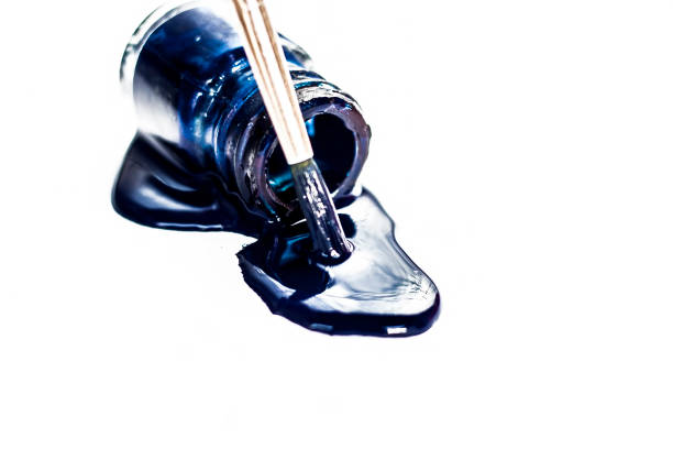 istock Blue colored poster water color bottle fallen or dropping on white surface or background. 981753900