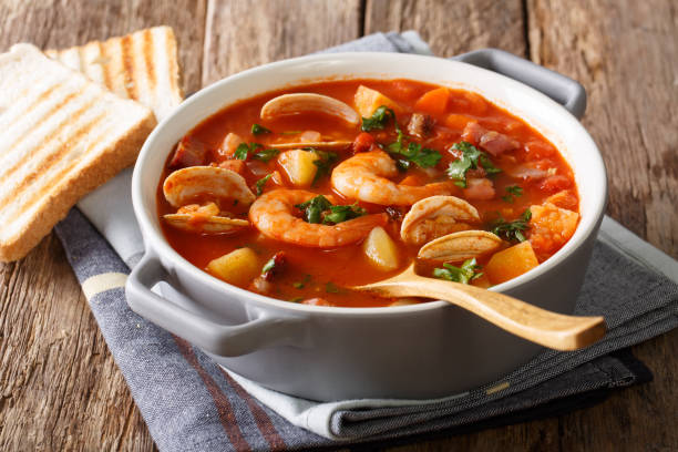 istock Delicious tomato clam chowder soup with shellfish and bacon close-up. horizontal 981760236