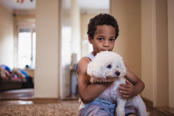 istock Cute, mixed race boy, playing with his dog 981760480