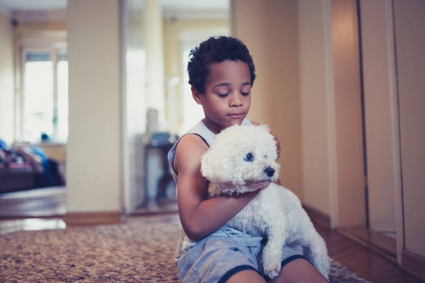 istock Cute, mixed race boy, playing with his dog 981760536