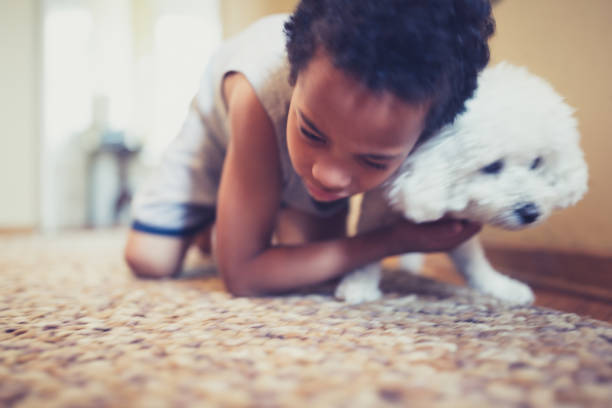 istock Cute, mixed race boy, playing with his dog 981760570