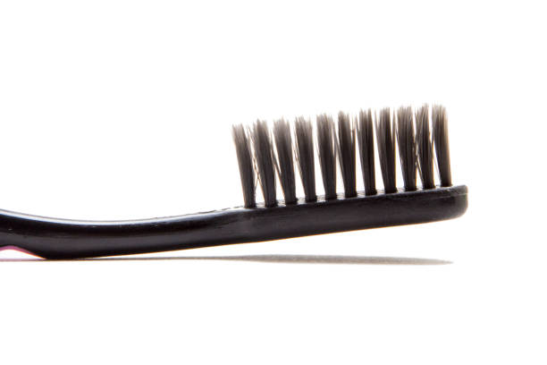 istock Black used toothbrush isolated on white 981764250