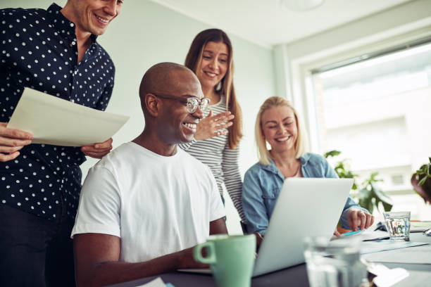 istock Diverse businesspeople smiling while working online together in an office 981765048