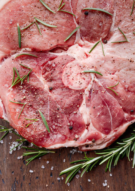 istock Raw pork with rosemary , salt and pepper. 981770276