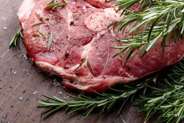 istock Raw pork with rosemary , salt and pepper. 981770398