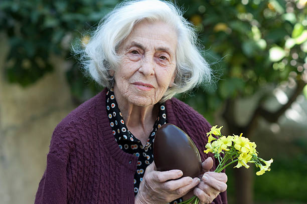 Senior woman with easter chocolate egg stock photo