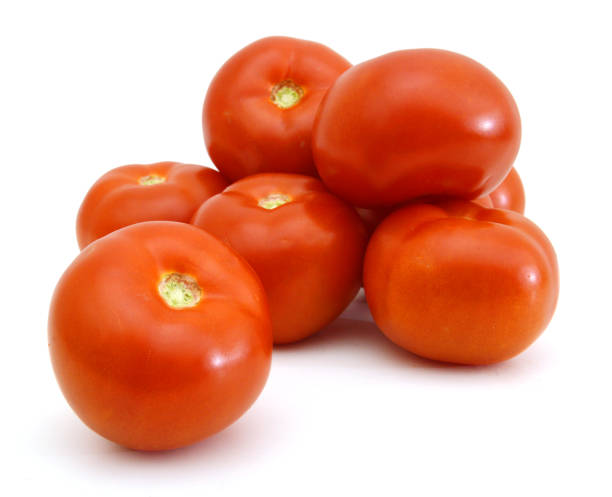 istock Closeup of tomatoes on the vine isolated on white 981782320
