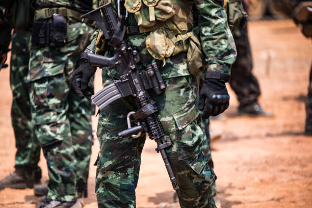 istock Midsection Of Army Soldiers With Rifle 981783550