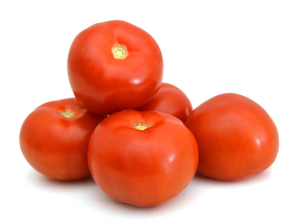 istock Closeup of tomatoes on the vine isolated on white 981783666