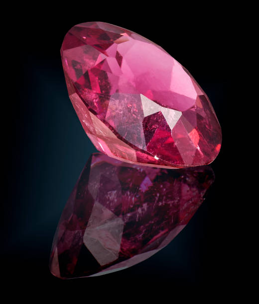 istock pink tourmaline gem stone isolated on black 981785308
