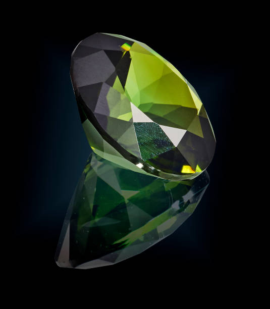 istock green tourmaline gem stone isolated on black 981787864