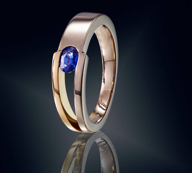istock Golden ring with gemstone isolated on black background 981788206