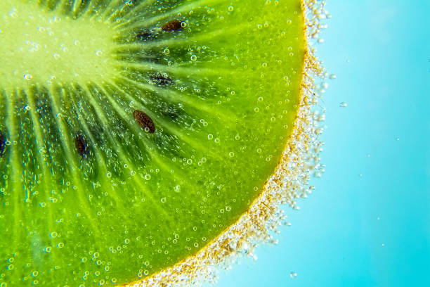 istock Kiwi water bubbles blue light background texture close-up macro. Bright view photo. 981788710