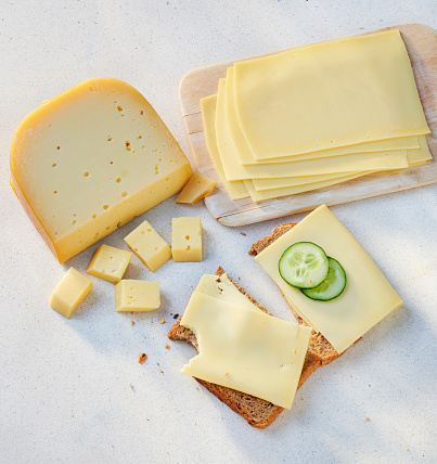 cheese pieces and slices on a slice of bread.
