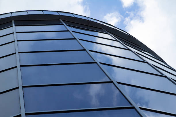 istock Sky reflected in a modern building blue glass facade 981789538
