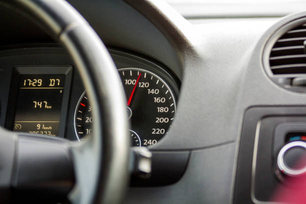 istock Close up interior view of modern luxurious black car. Dashboard, steering wheel, speedometer. Speed, comfort and luxury. 981794400