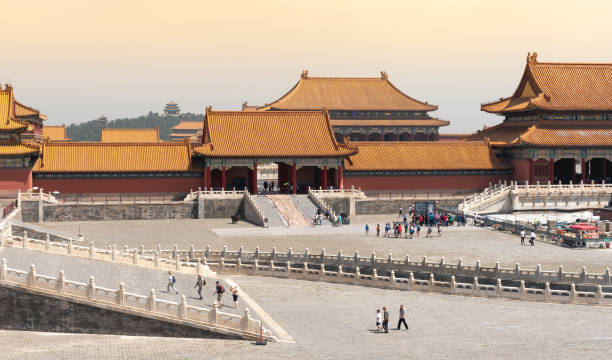 Forbidden palace buildings and people in Beijing China Beijing, China â June 5 2018: Traditional buidlings of the famous Forbidden palace city with a tourist people walking around in Beijing, China. forbidden city beijing architecture chinese ethnicity stock pictures, royalty-free photos & images