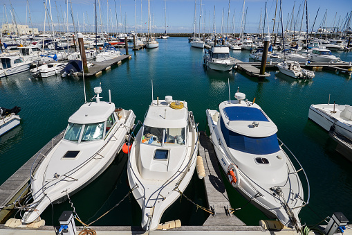 Cascais, Portugal - June 8th, 2018: Ultra wide angle of yacht and motor boats docked at Cascais marina. The Marina is located under Cascais Cidadela