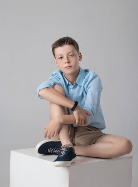 istock boy posing in fashionable shirt and shirts in studio 981806362