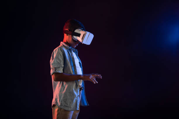 istock Happy boy wearing a modern VR headset 981819760