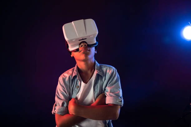 istock Meditative schoolboy wearing a modern VR headset 981820342