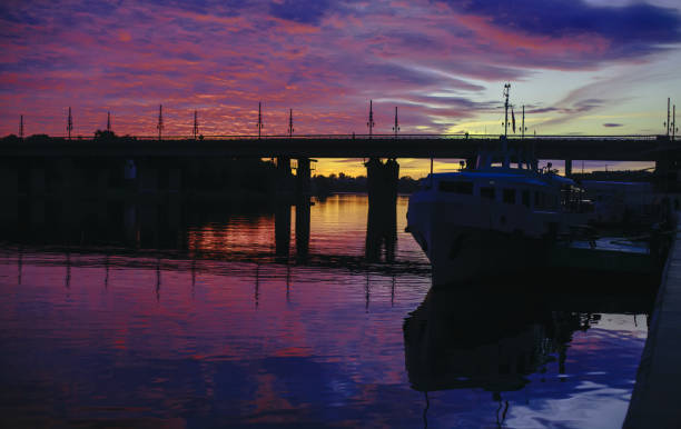 istock Silhouette of the waterfront and the bridge at sunset 981825268