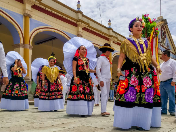 San Cristobal, Mexico - April 14, 2014: Tzotzil women walking in San Cristobal de las Casas, Chiapas dressed in traditional clothing. They sell crafts and traditional merchandise to tourists.