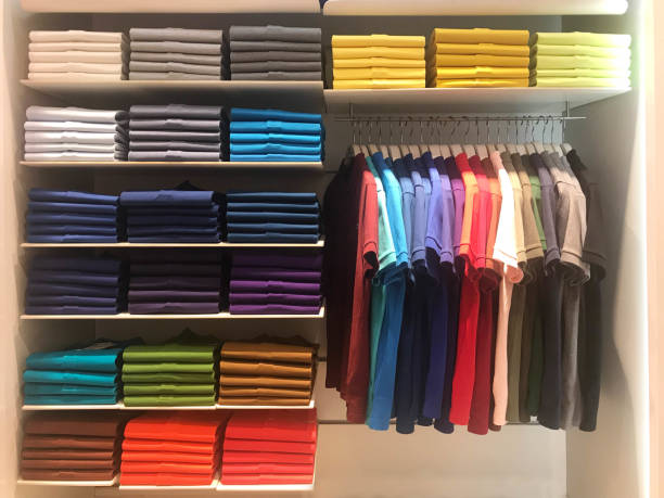 Colorful polo shirts on hanger and shelves in shopping mall Multi color polo shirts on hanger and shelves for sale in store garment store fashion rack stock pictures, royalty-free photos & images