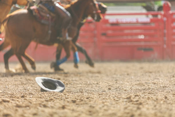 A cowgirl at a rodeo looking contemplative