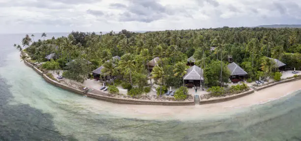 A luxurious tropical resort looks out on a beautiful reef flat in Wakatobi National Park, Indonesia. This area harbors an amazing array of marine biodiversity and is within the Coral Triangle.