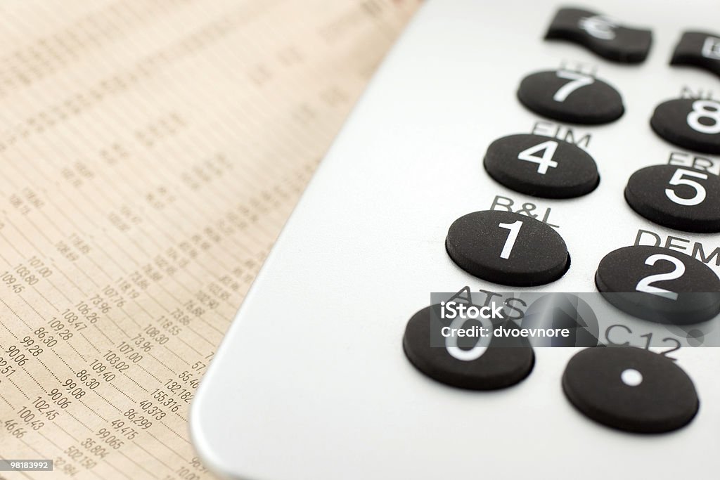 financial newspaper with calculator  Analyzing Stock Photo