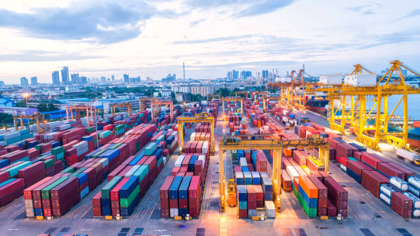 istock Container ship in export and import business and logistics. Shipping cargo to harbor by crane. Water transport International. Aerial view and top view. 981842330
