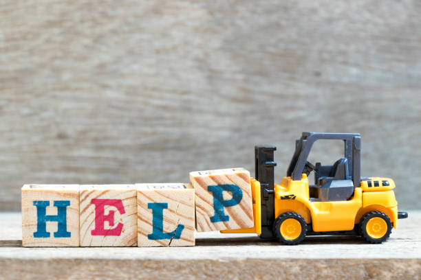 istock Toy forklift hold letter block P to complete word help on wood background 981843074