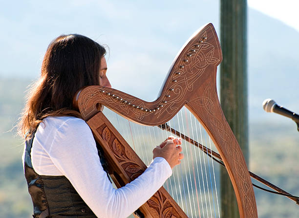istock Young Woman playing a harp 98184374