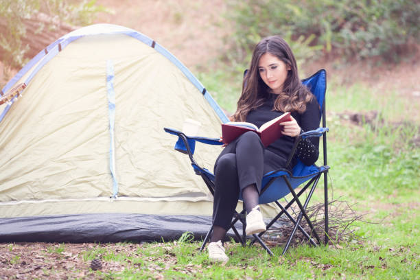 istock Smiling woman reading a book. 981851610