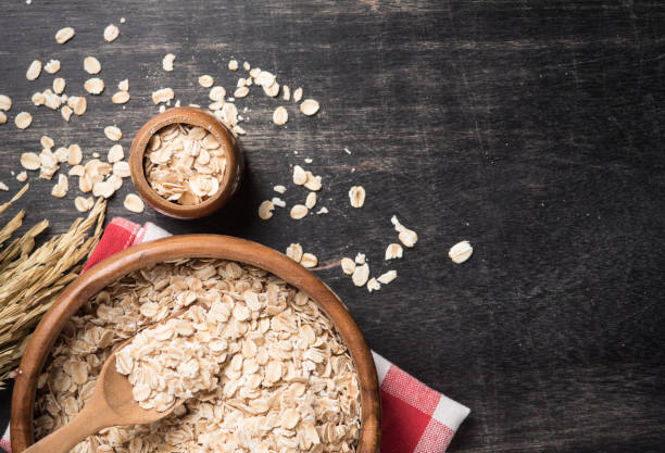 istock Oatmeal or oat flakes on dark wooden table 981854968