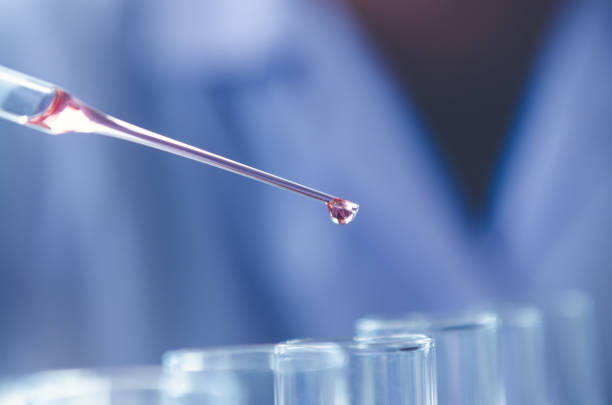 istock A pipette dropping sample into a test tube,abstract science background 981863506