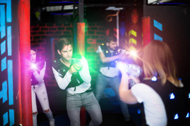istock Guy in colored beams during laser tag game 981864288
