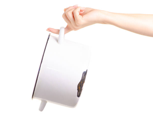 istock Old enamel saucepan battered in hand 981865774