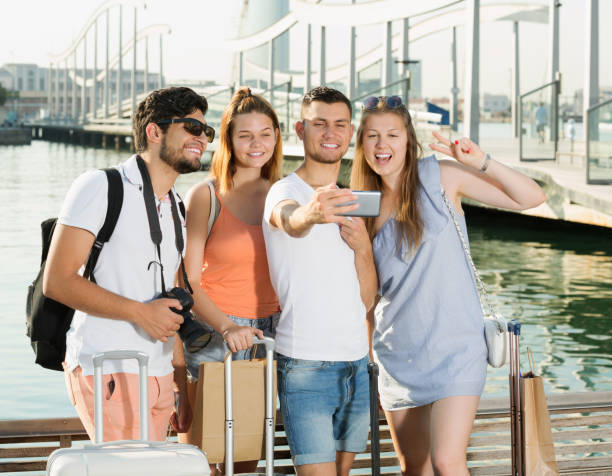 istock Happy friends travellers smiling and making selfie 981865822