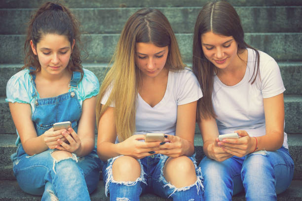 istock Three Teenage Girls Using Their Smartphones 981871498