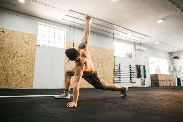 istock Man stretching in the gym 981872186