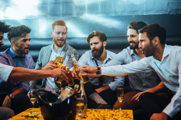 Cheers to good times with mates ! Group of young men toasting with beer stag night stock pictures, royalty-free photos & images