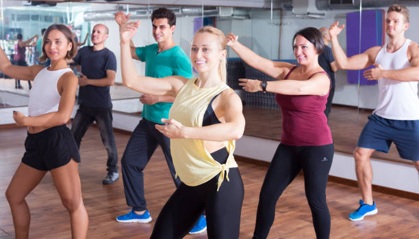 istock Men and ladies dancing zumba 981878528
