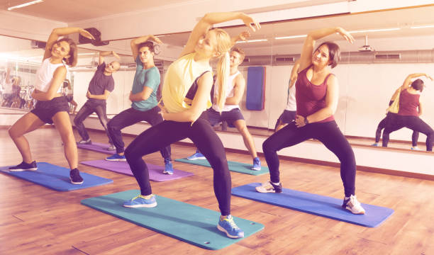 istock Group of young smiling  people studying zumba elements 981878560