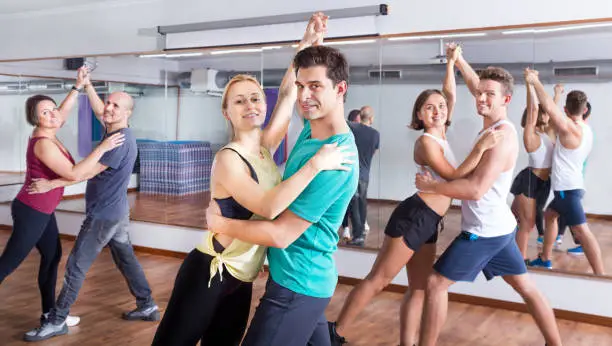 Photo of Men and women dancing salsa o bachata